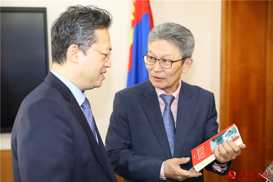 其米德策耶（右一）向李峙介紹翻譯成果。人民網(wǎng)記者 霍文攝