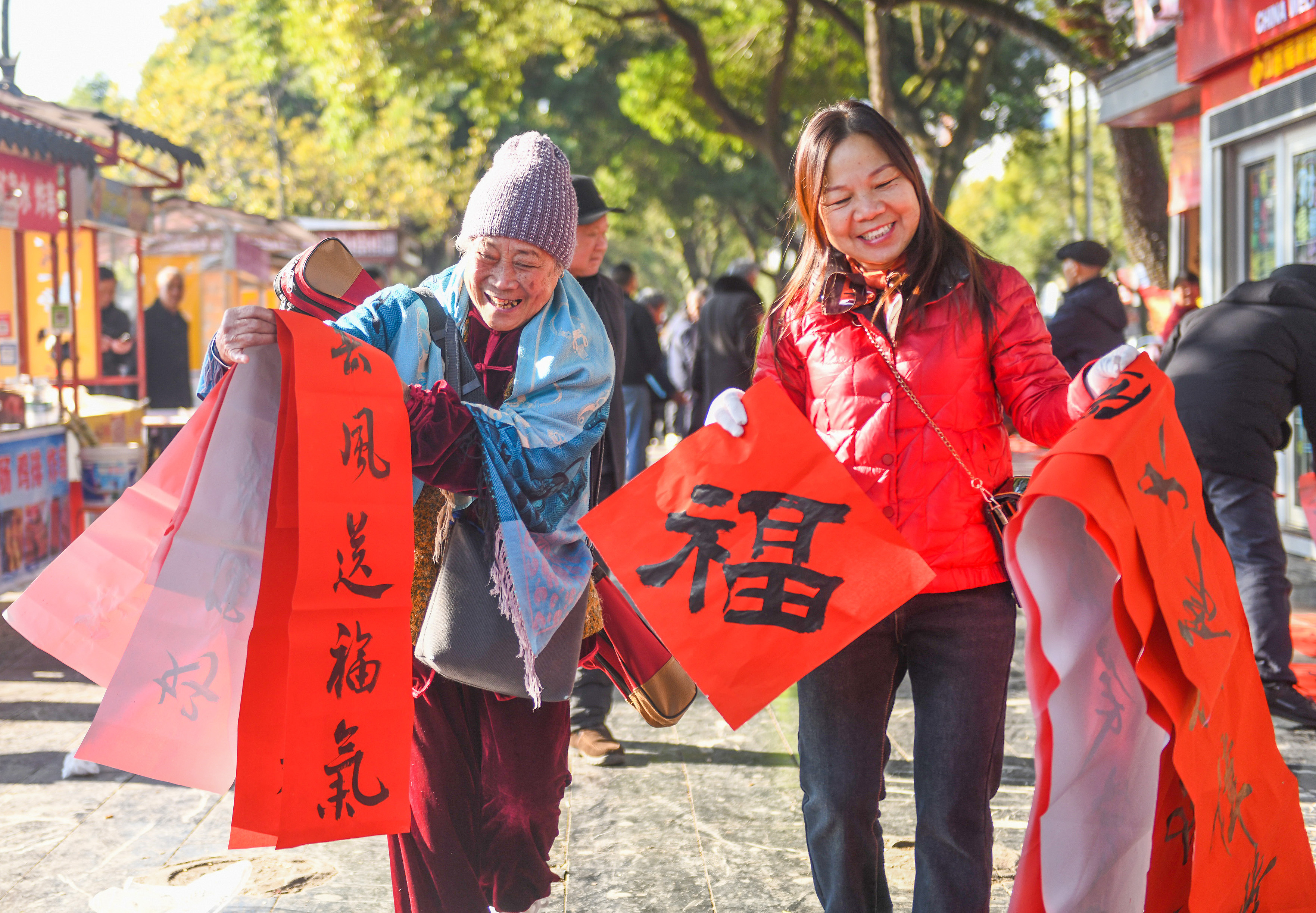 2025年1月13日，在湖南省永州市道縣西洲公園義工崗?fù)?，市民們領(lǐng)到了書法志愿者為大家書寫的春聯(lián)。